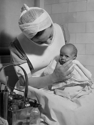 Hansel Mieth - The LIFE Picture Collection/Getty Images/Caption from LIFE. "Seven-months baby gets back massage to belch."