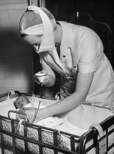 Hansel Mieth - The LIFE Picture Collection/Getty Images/Caption from LIFE. "Three-pound babies are fed by placing rubber tube down their throats, pouring milk through a funnel into the tube. Such feeding conserves the baby's strength."